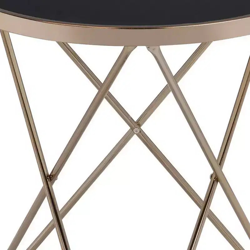 Tavolino con piano in vetro temperato nero e struttura in metallo color champagne